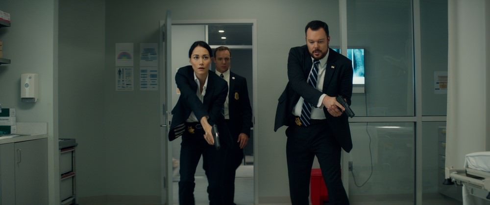 Left to right: Sandrine Holt plays Detective Cheung, Matty Ferraro plays Agent Janssen, and Michael Gladis plays Lieutenant Matias in Terminator Genisys from Paramount Pictures and Skydance Productions.